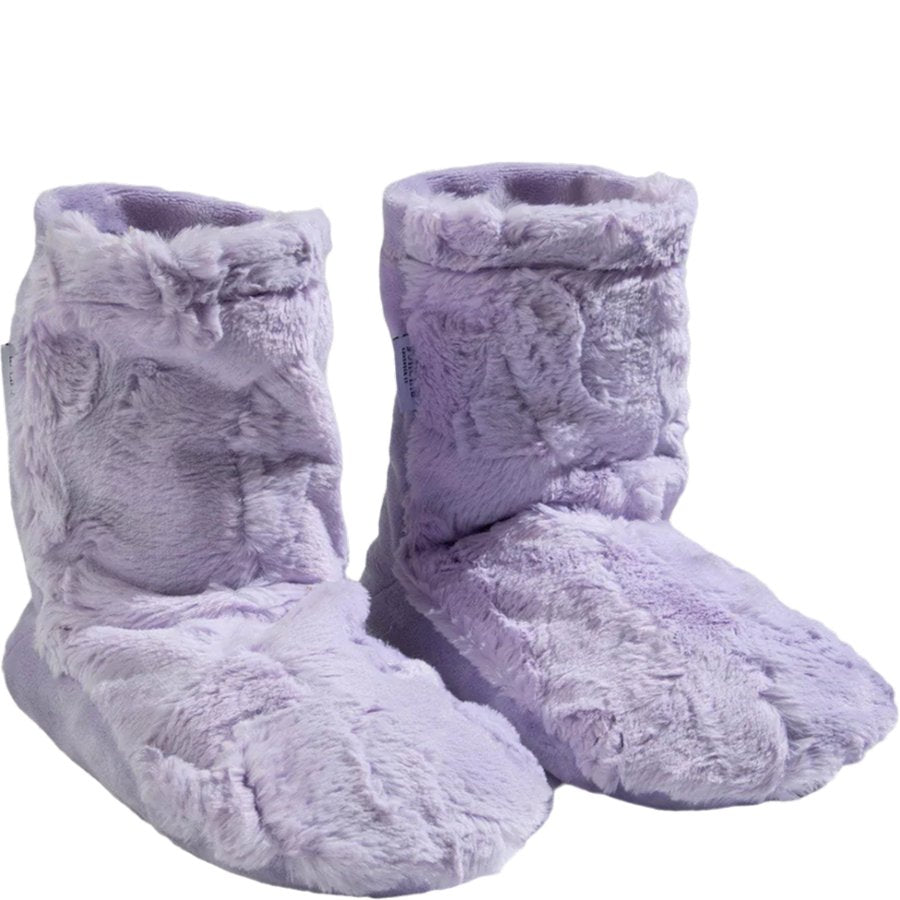 Pair of purple fuzzy slippers on a white background