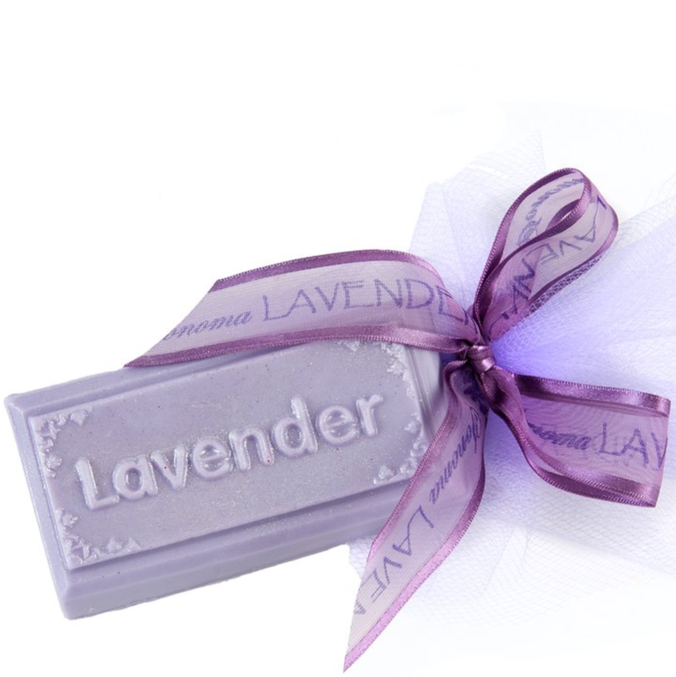 Lavender soap bar with a purple ribbon on a white background