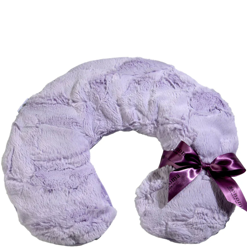 Fluffy lavender neck pillow with a pink satin bow on a white background