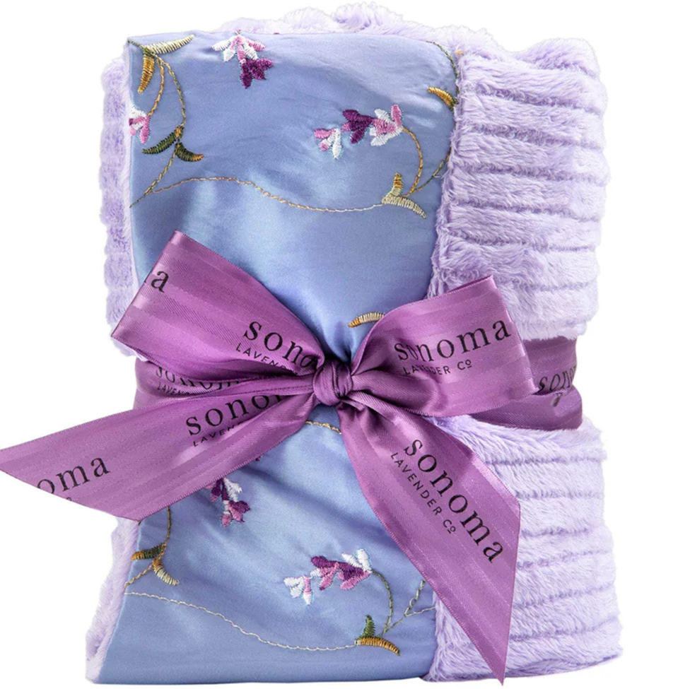 Floral embroidered blanket with a Sonoma Lavender Co. ribbon on a white background