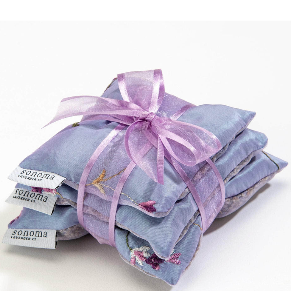 Stack of lavender bags with a pink ribbon on a white background, featuring the Sonoma Lavender Co. brand.
