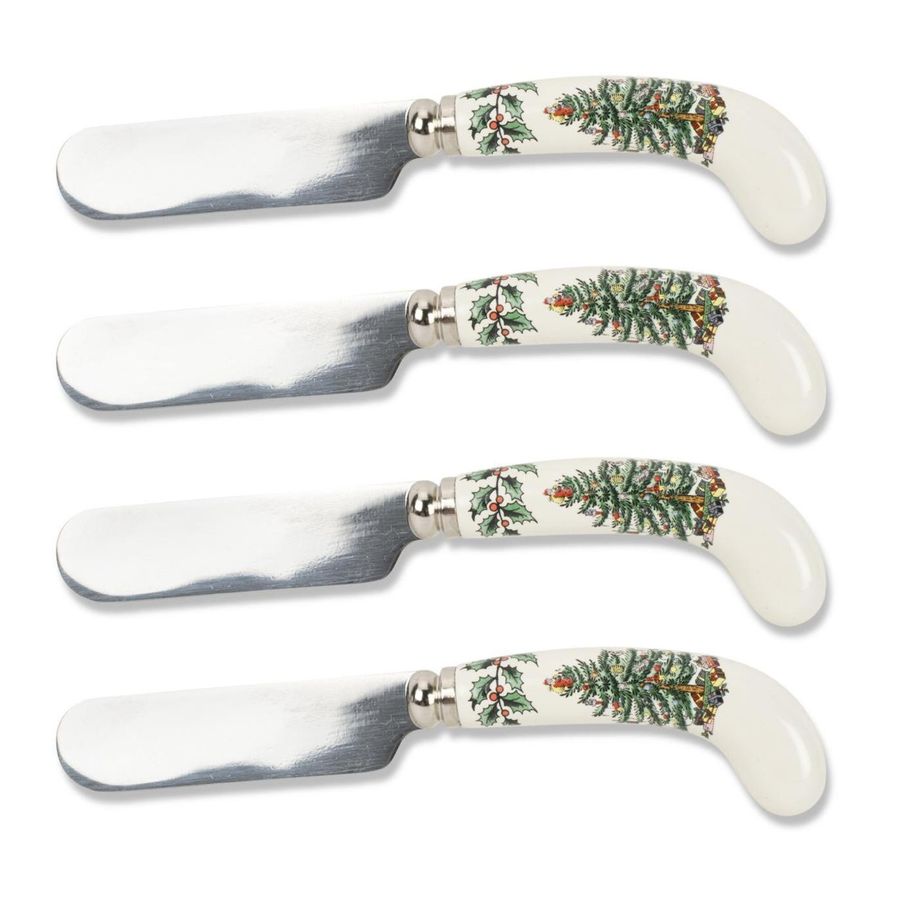 Set of four butter knives with decorative handles on a white background