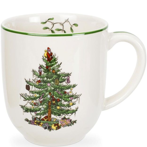White mug with a Christmas tree design and Santa Claus on a white background