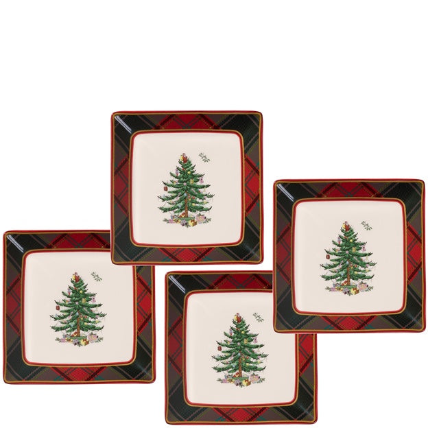 Set of four square plates with Christmas tree design on a white background