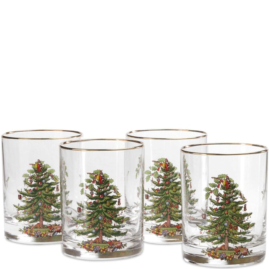 Set of four clear glasses with Christmas tree designs on a white background