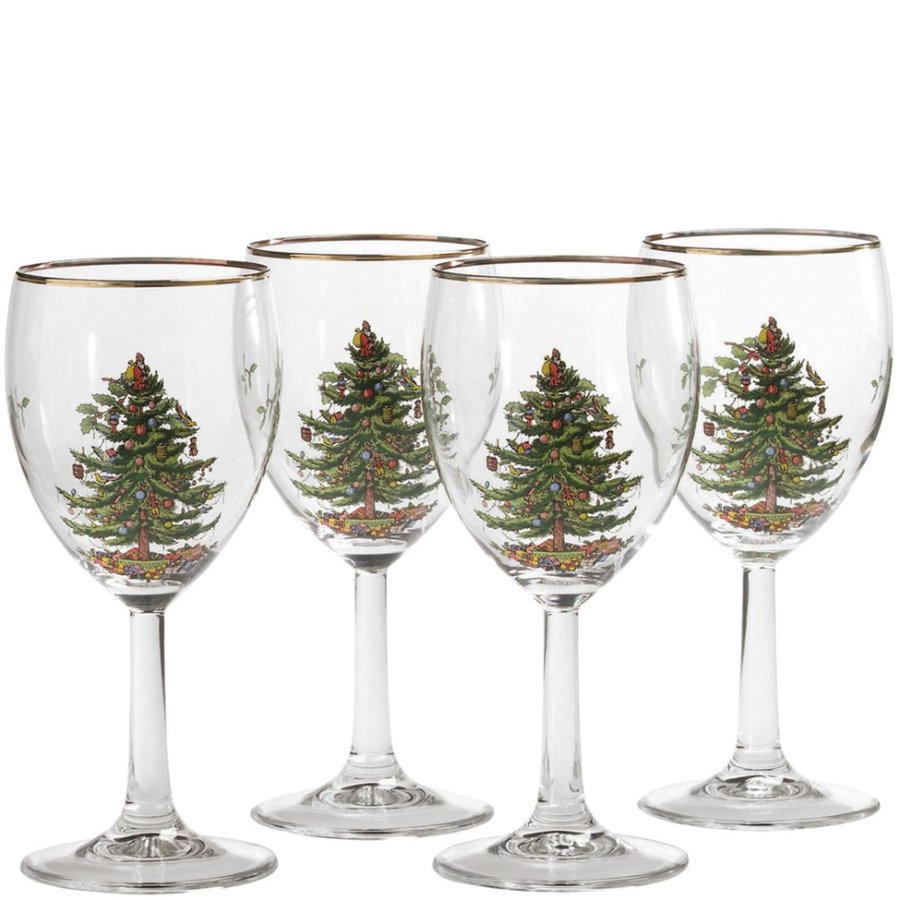 Four wine glasses with Christmas tree design on a white background