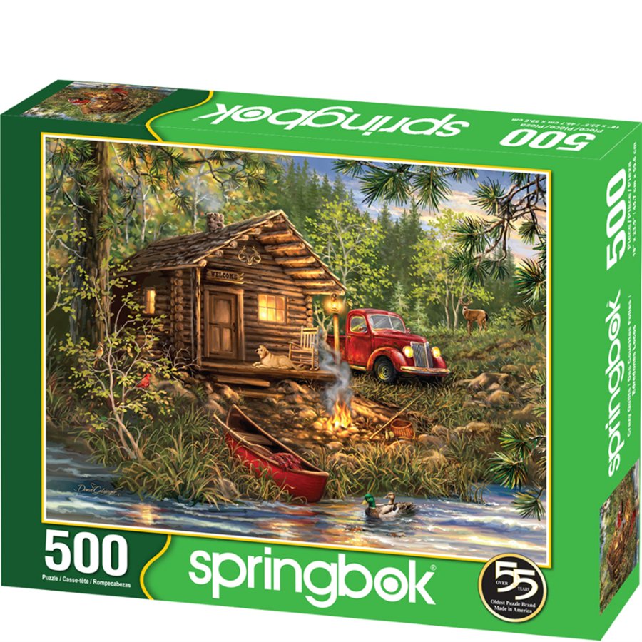 Springbok 500-piece puzzle box with a cabin and red truck scene