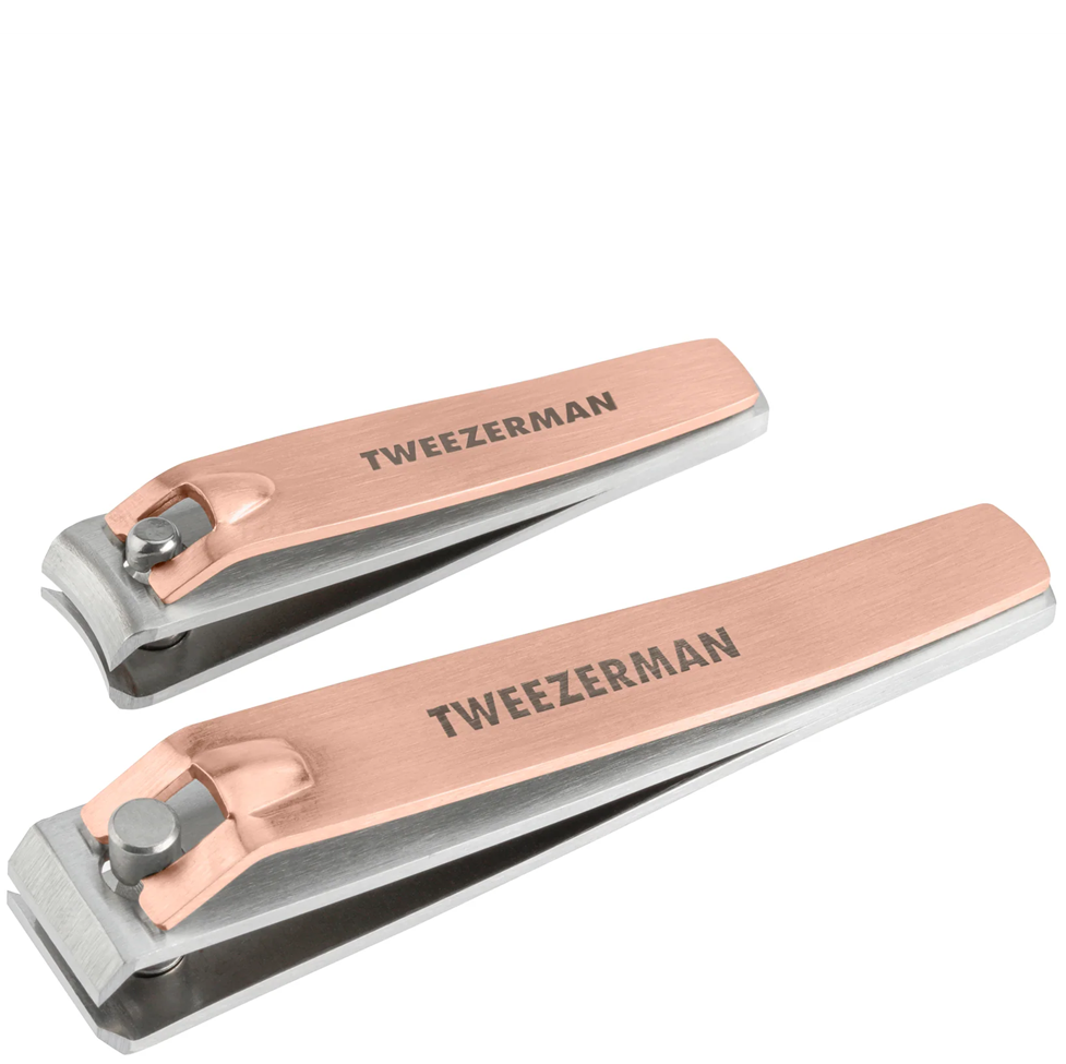 Rose gold and silver nail clippers with 'Tweezerman' branding on a white background