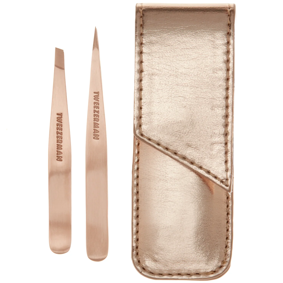 Rose gold tweezers with a matching case on a white background