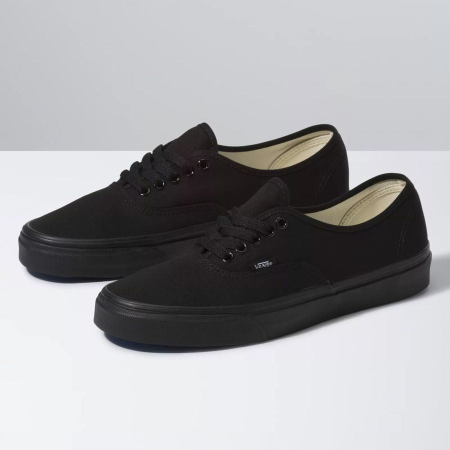 Pair of black sneakers on a white background