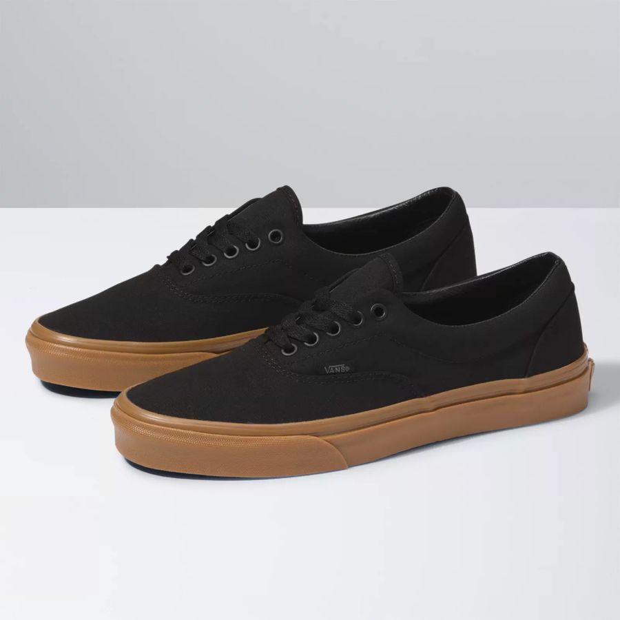 Black sneakers with brown soles on a white background