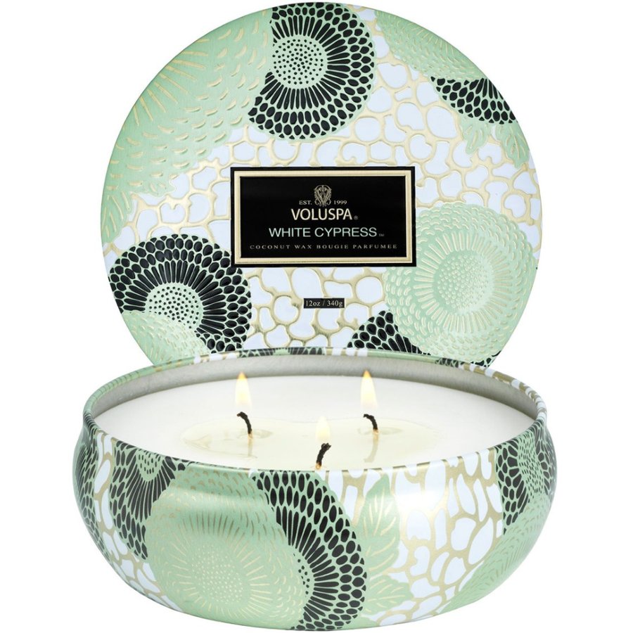 Decorative candle in a tin with a patterned lid, featuring the brand 'VOLUSPA'.