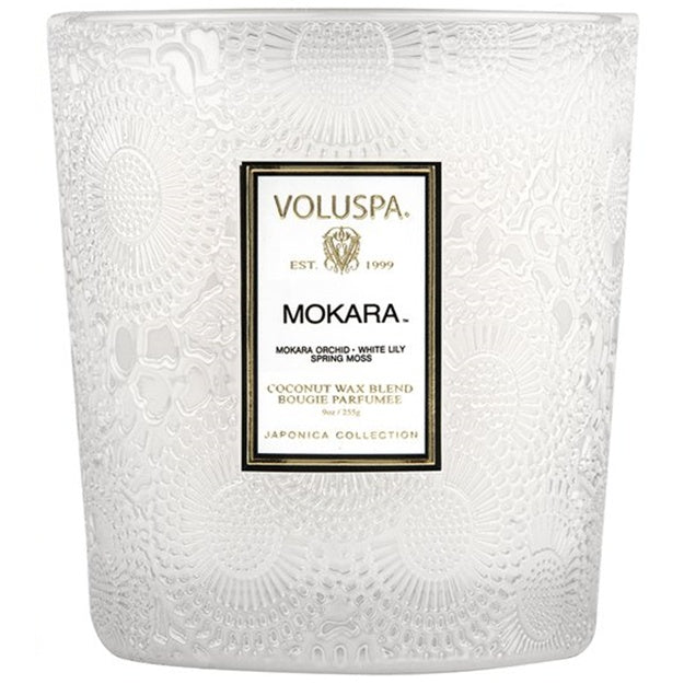 White textured candle with Voluspa Mokara label on a white background