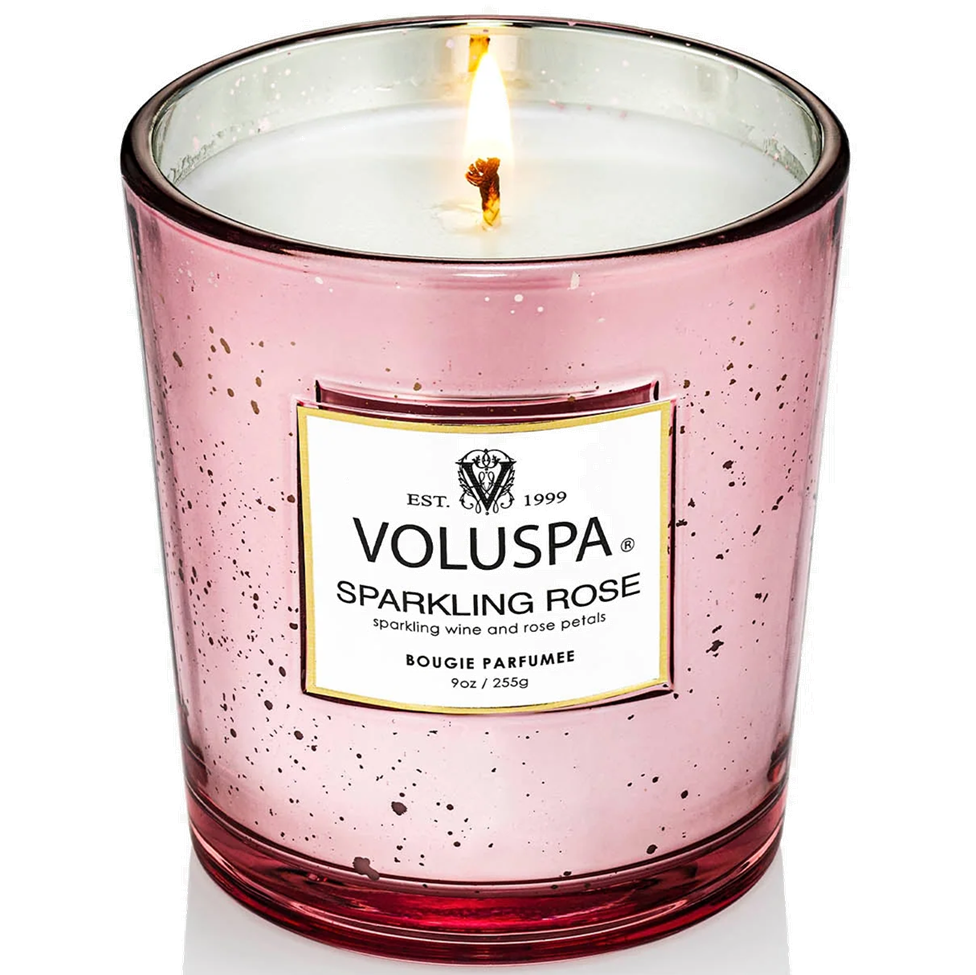 Pink Voluspa candle with a label on a white background