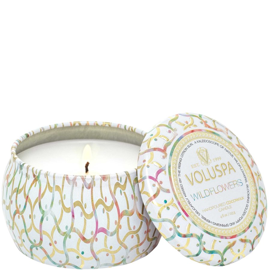 Voluspa candle with colorful lid design on a white background