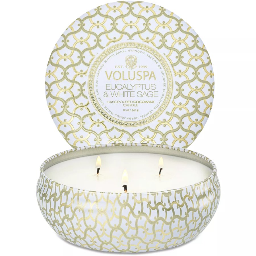 Voluspa candle in a decorative tin with a white and gold pattern