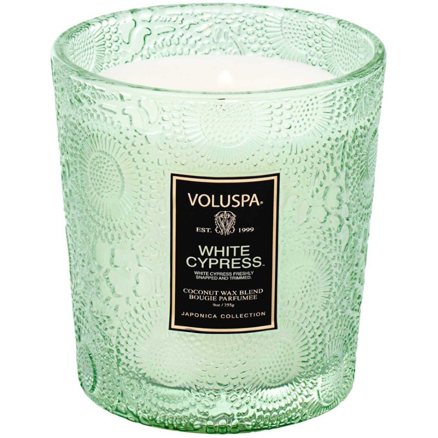 Green textured candle with Voluspa label on a white background