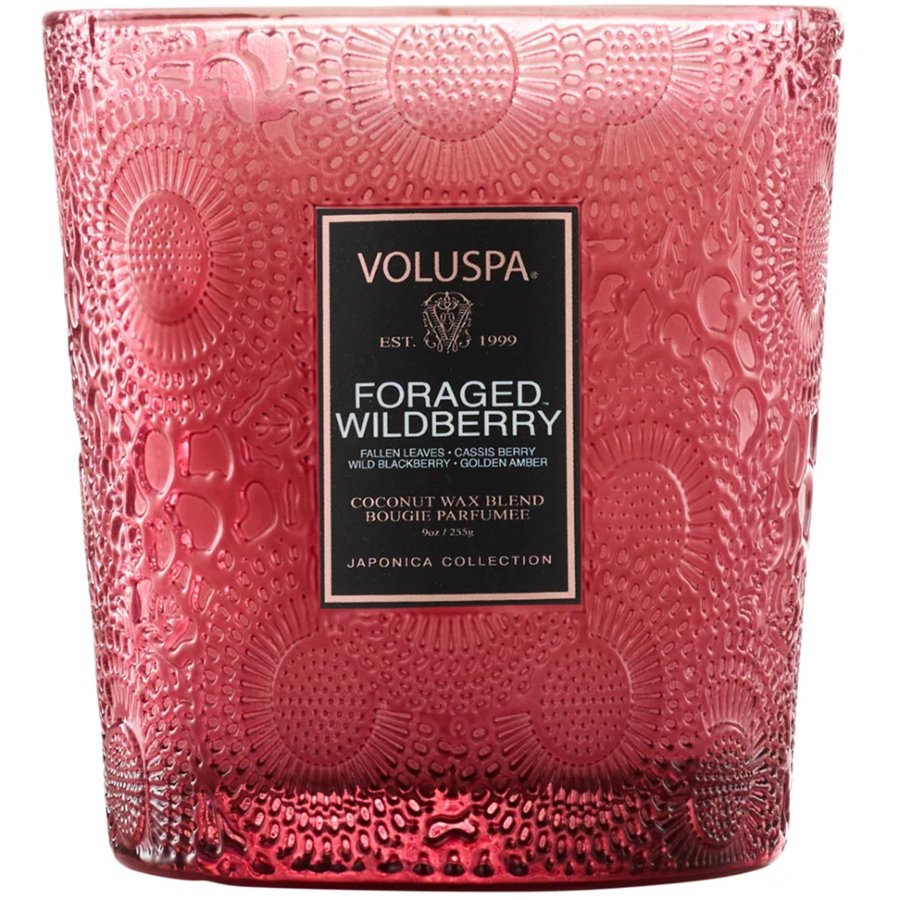 Pink textured Voluspa candle with 'Foraged Wildberry' label on a white background