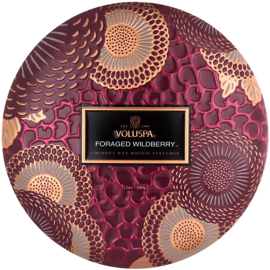Decorative Voluspa candle packaging with intricate patterns on a white background