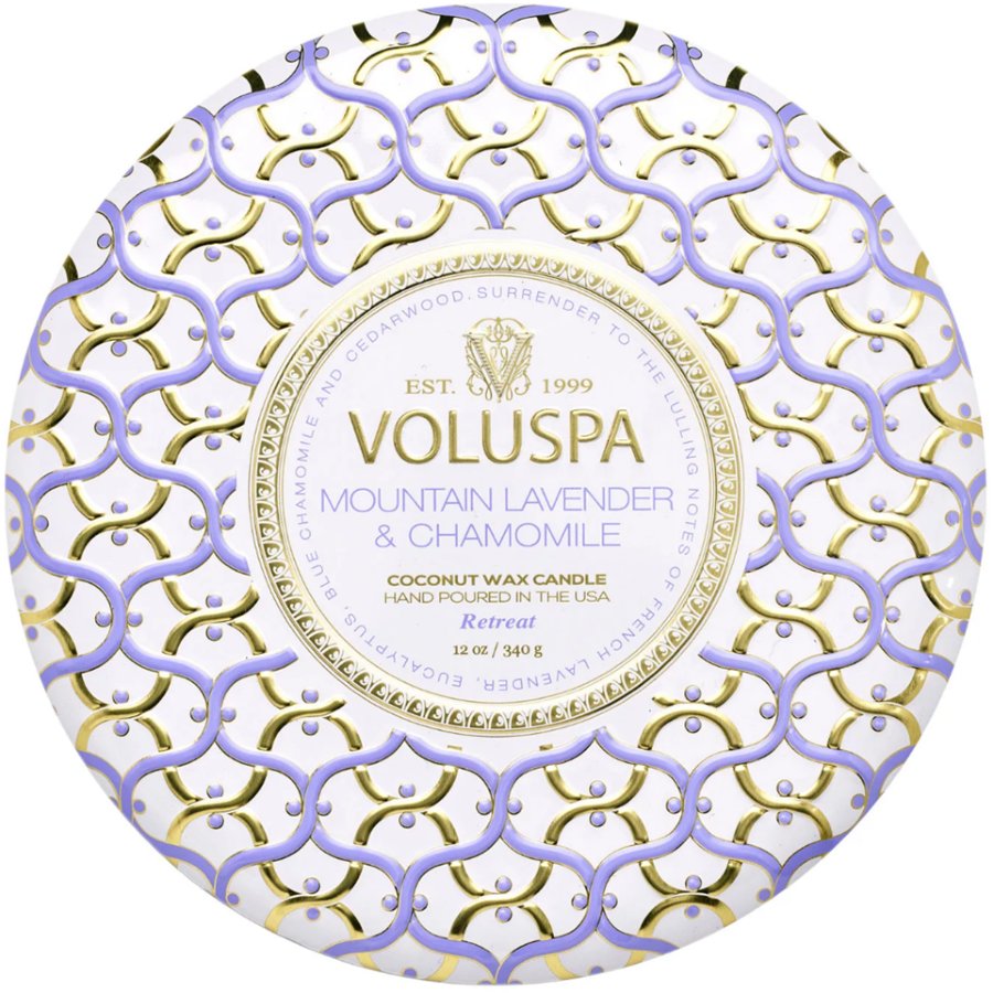 Decorative Voluspa candle packaging with intricate patterns and branding.