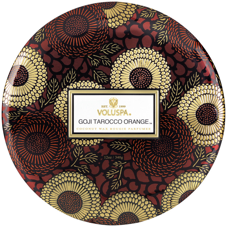 Decorative container with Voluspa branding and a floral pattern on a white background