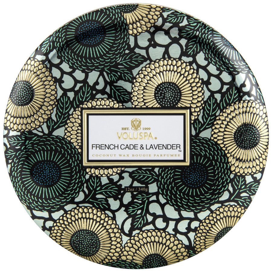 Decorative tin with floral pattern and Voluspa branding on a white background