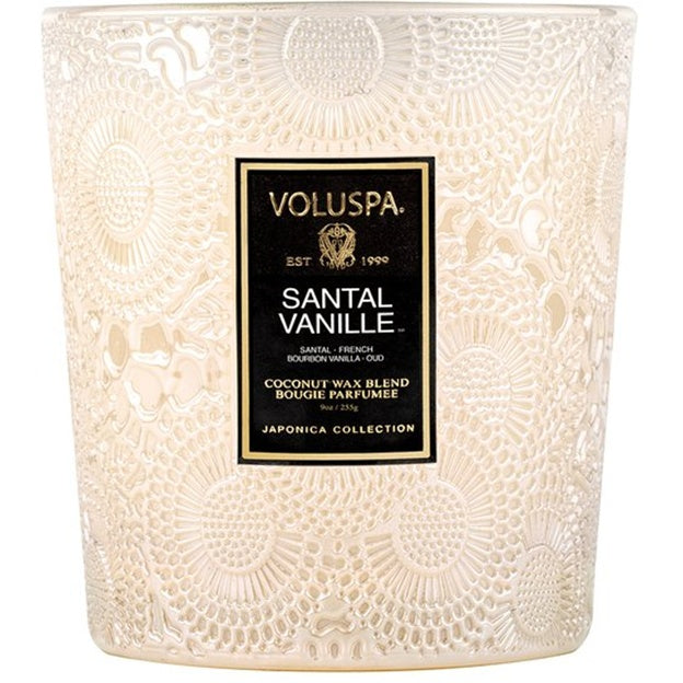 Decorative candle with Voluspa label on a white background