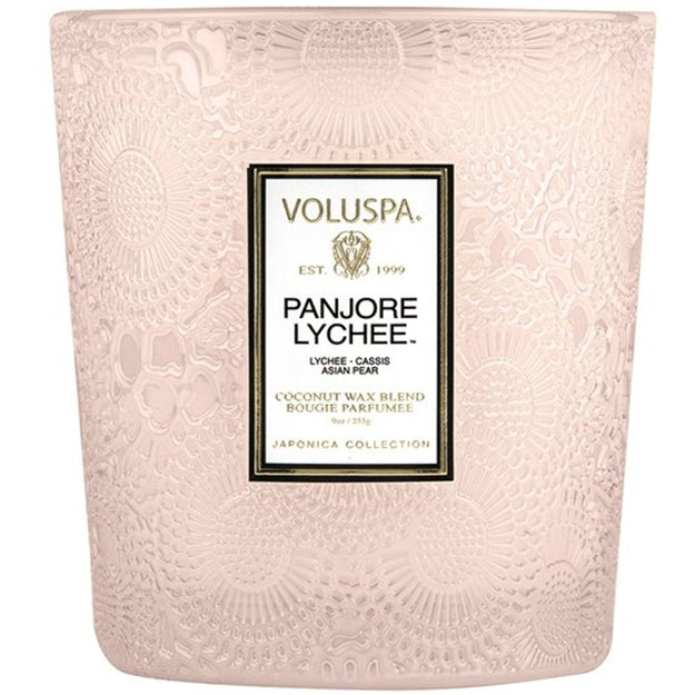 Pink textured candle with Voluspa Panjore Lychee label on a white background