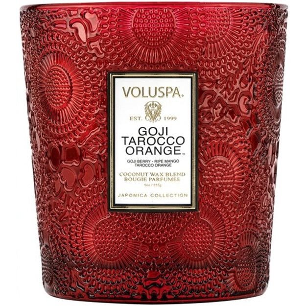 Red embossed candle with Voluspa label on a white background