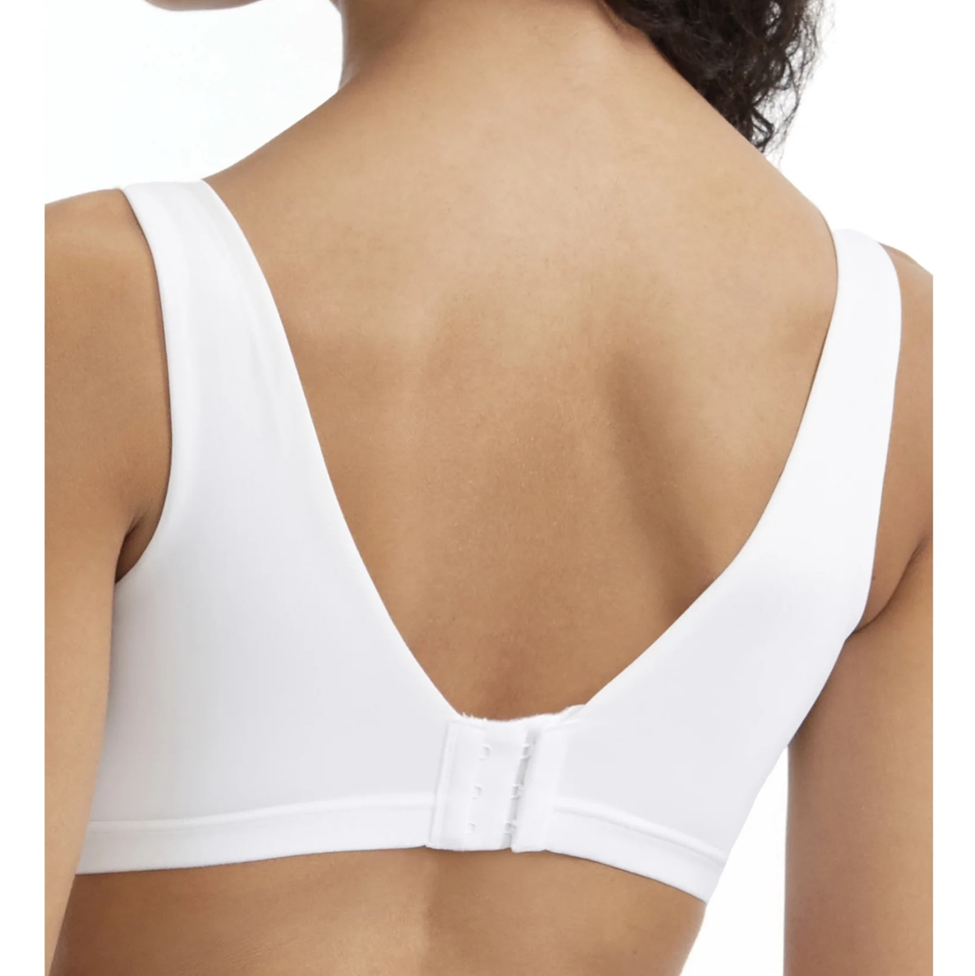 White sports bra on a model with a plain background