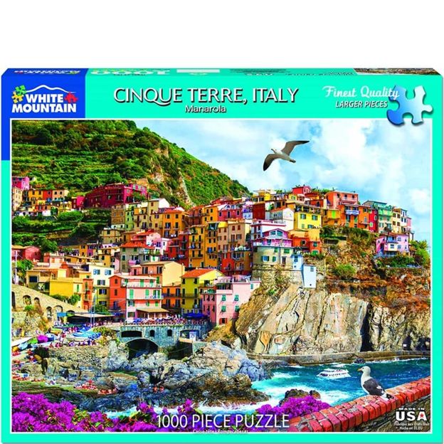 Jigsaw puzzle packaging featuring Cinque Terre, Italy with colorful buildings and a seagull.