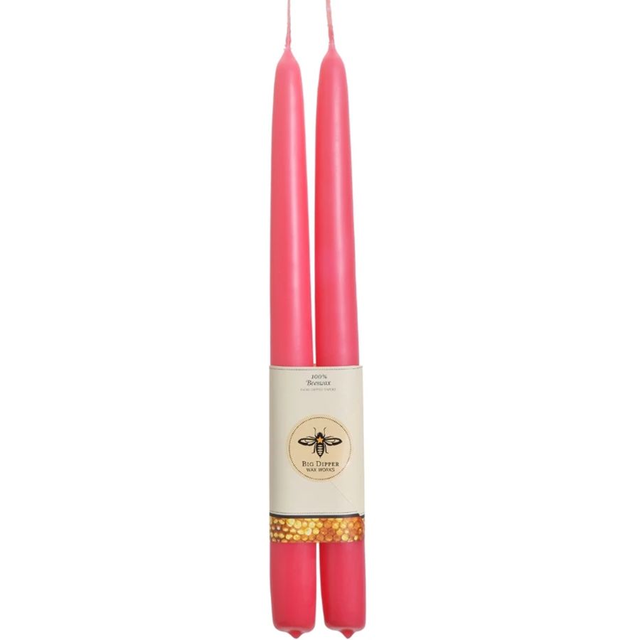 Two pink candles with a label on a white background