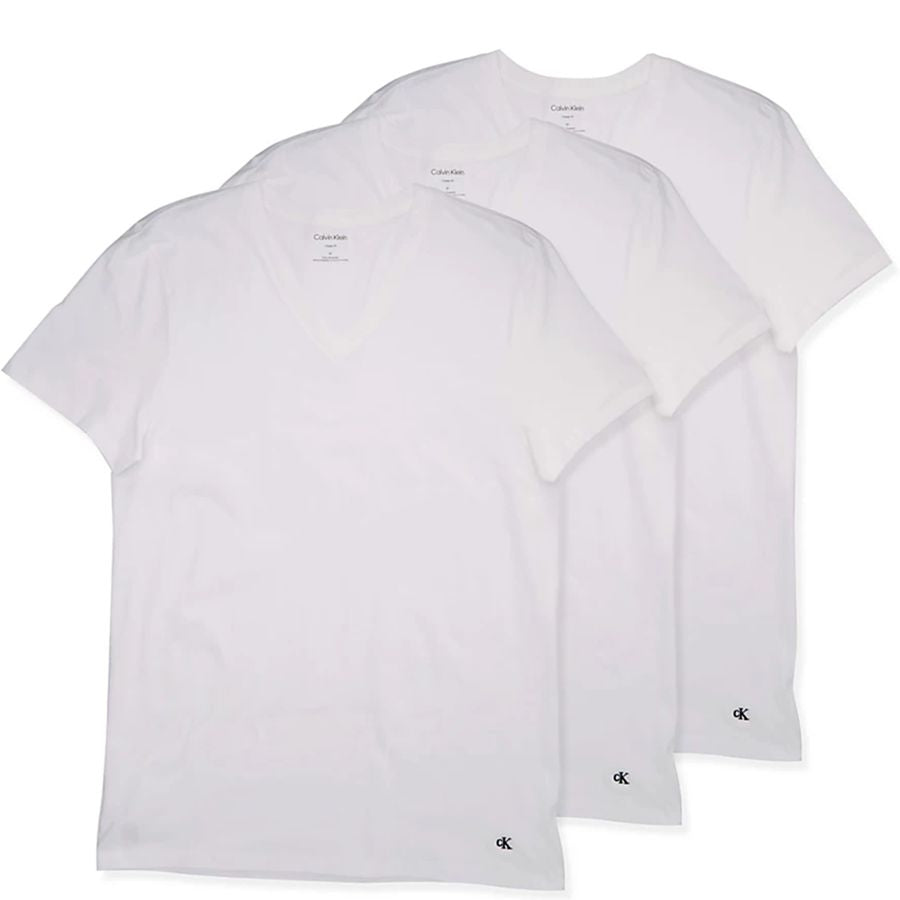 Three white short-sleeve crewneck t-shirts from Calvin Klein, arranged in a diagonal stack on a white background. Each shirt features a small black Calvin Klein logo printed near the bottom hem.