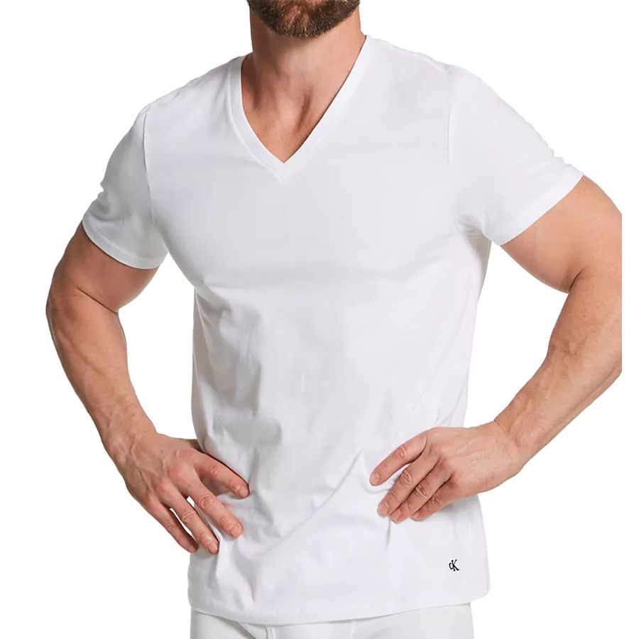 A man wearing a white short-sleeve V-neck t-shirt, shown from the chin down against a plain white background.