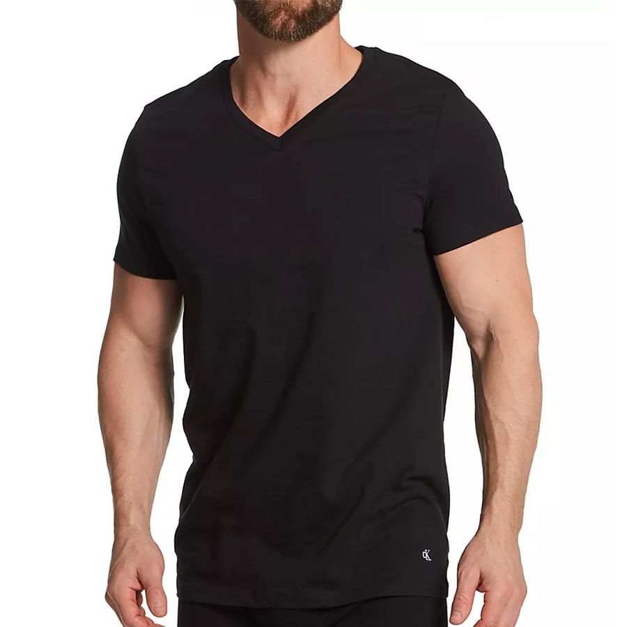 A man wearing a black short-sleeve V-neck t-shirt, shown from the chin down against a plain white background.
