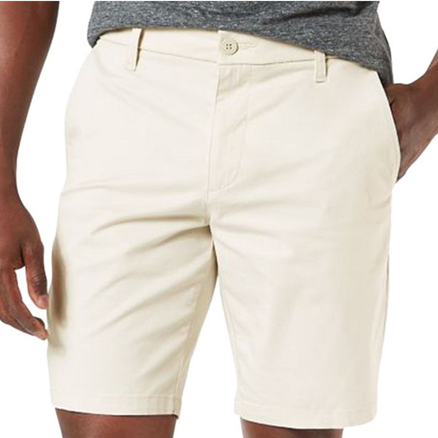 Beige shorts worn by a person on a white background
