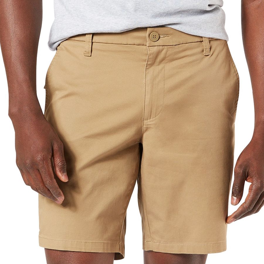 Beige shorts worn by a person on a white background
