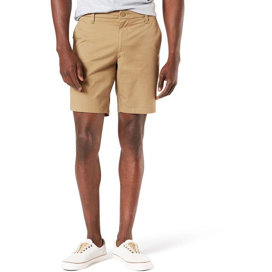 Beige shorts worn by a person on a white background