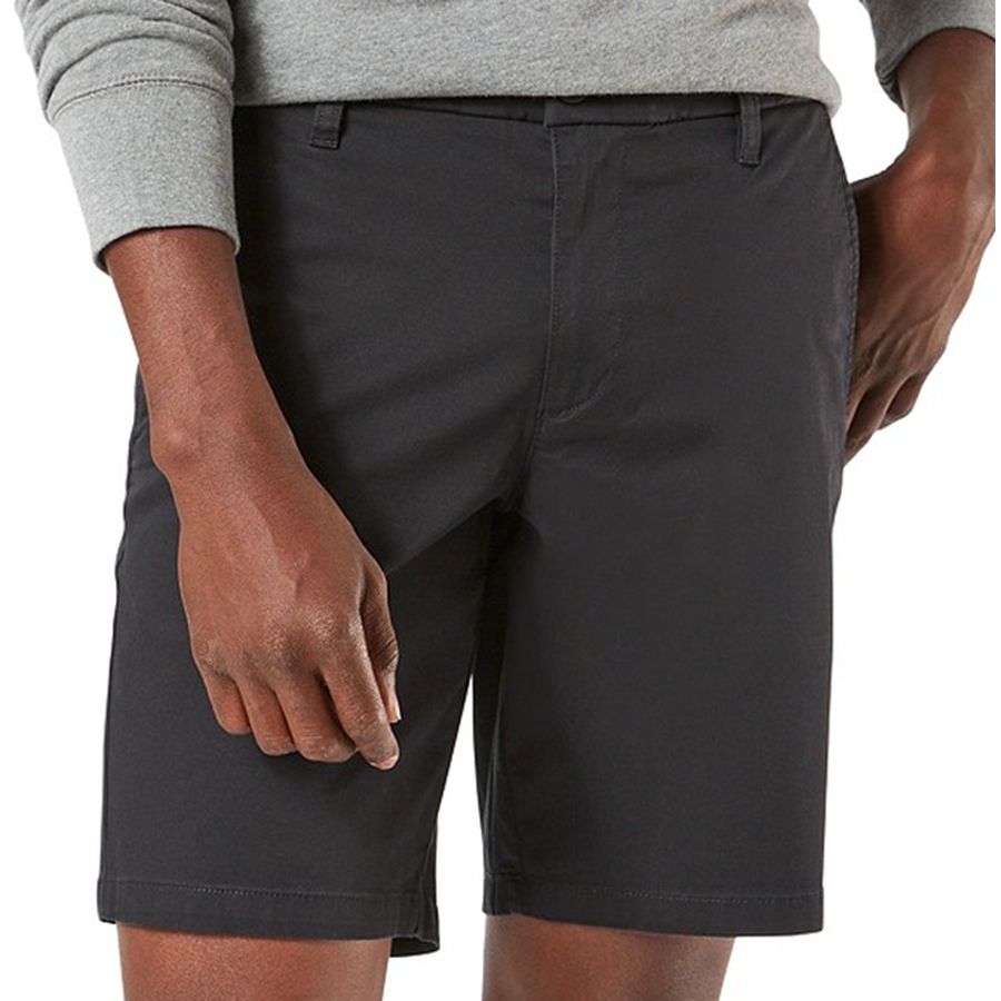 Person wearing dark gray shorts on a white background