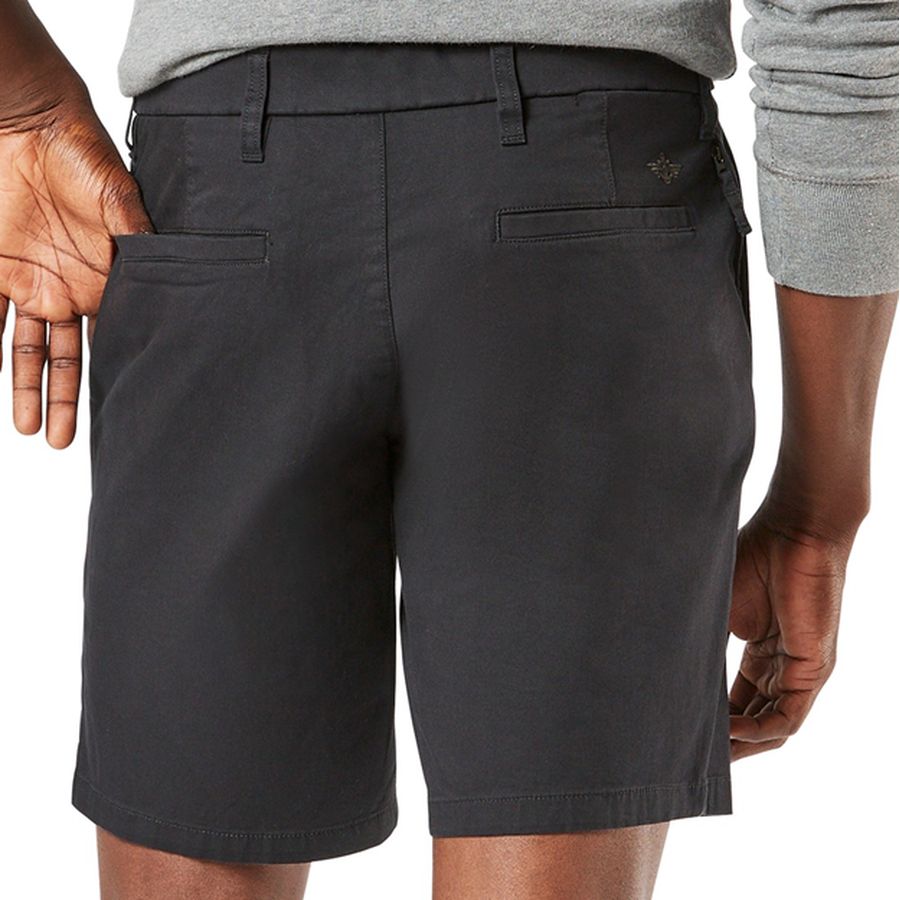 Person wearing black shorts with a visible brand logo on a white background