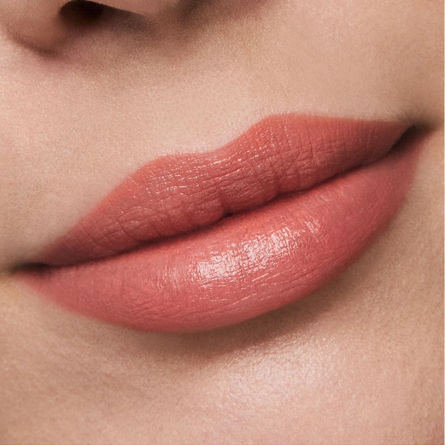 Close-up of a person's lips with a soft pink lipstick