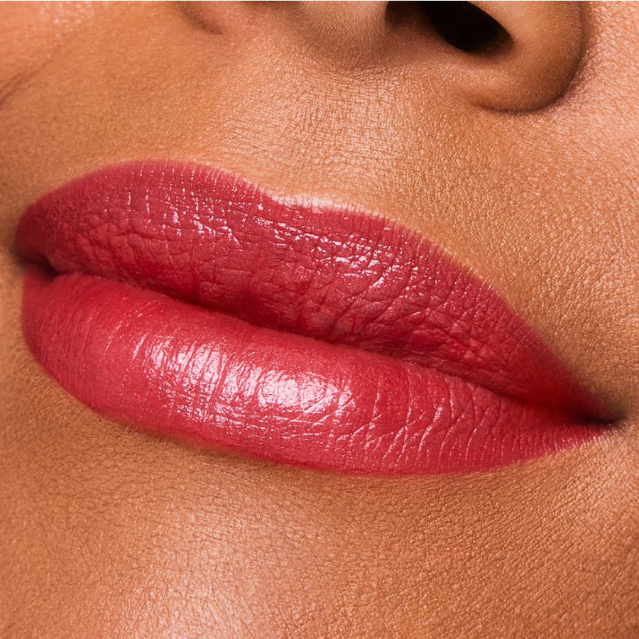 Close-up of a person's lips with a glossy pink lipstick on a skin-toned background