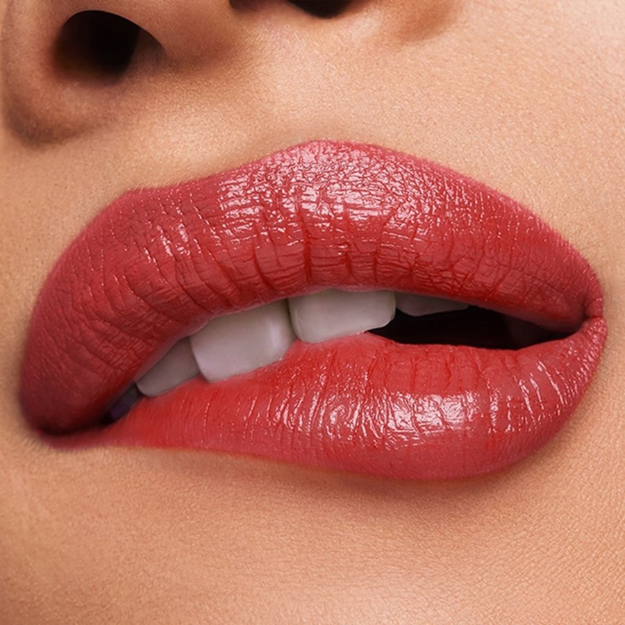 Close-up of a person's lips with a glossy red lipstick