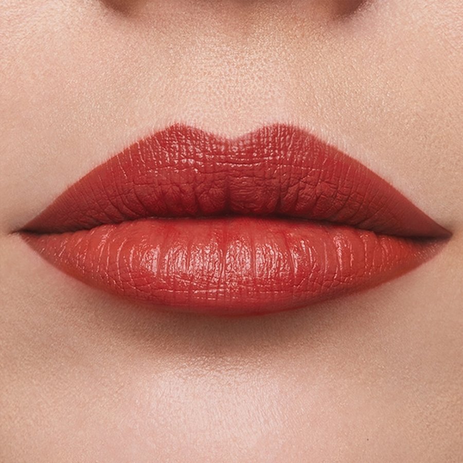 Close-up of a person's lips with red lipstick on a beige background