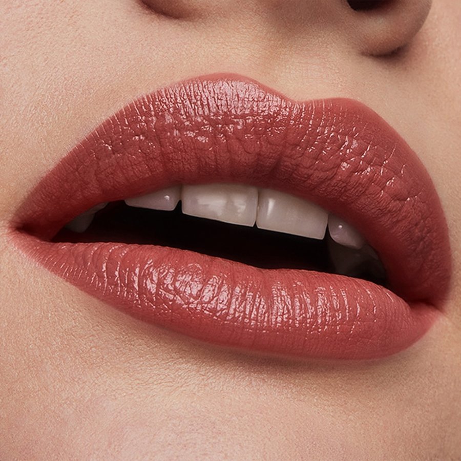 Close-up of a person's lips wearing a pink lipstick