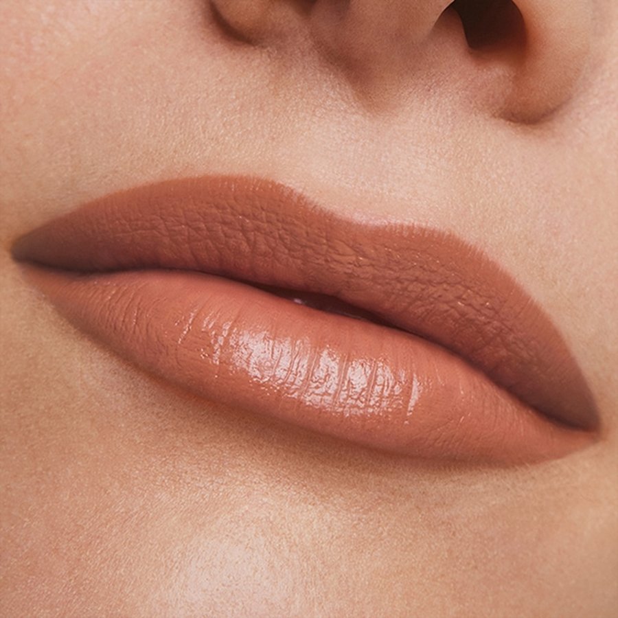 Close-up of a person's lips with a soft brown lipstick