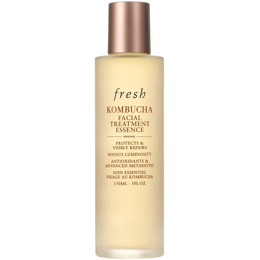 Fresh brand Kombucha Facial Treatment Essence in a clear bottle with rose gold cap, containing light yellow liquid. Text labels visible.