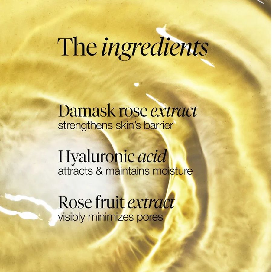 A close-up of a golden yellow liquid with text overlay reading 'The ingredients' and listing Damask rose extract, Hyaluronic acid, and Rose fruit extract.