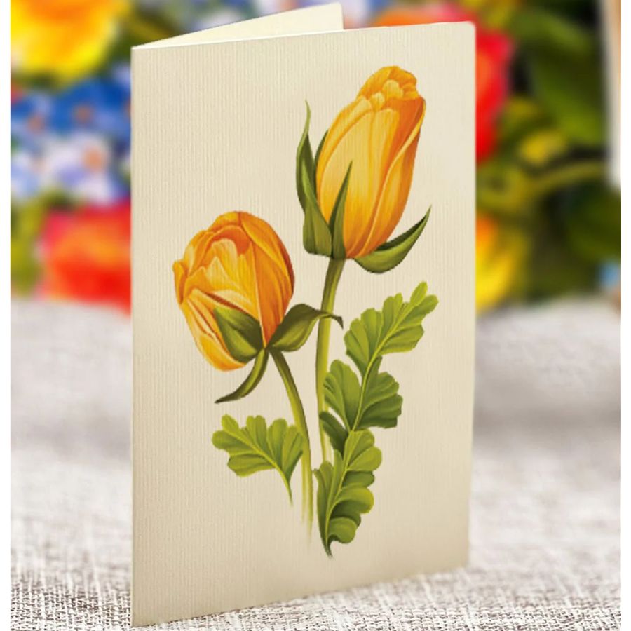Card with yellow floral design on a textured surface