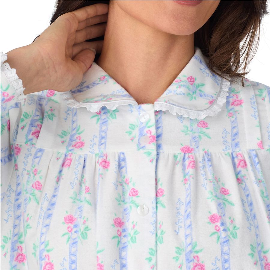 Close-up of a woman wearing a white floral nightgown with blue stripes and lace collar.